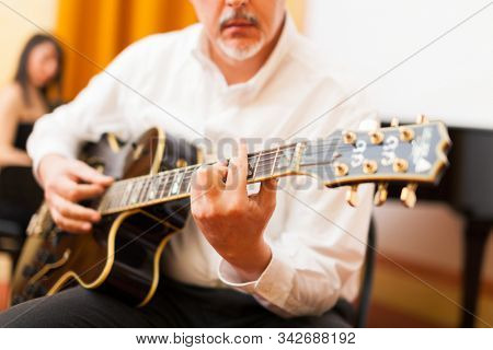 Guitarist playing an archtop guitar
