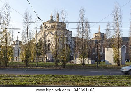 Milan, Italy - January 01, 2020: Exterior Of Cimitero Monumentale Of Milano In Milan; Cars Passing B