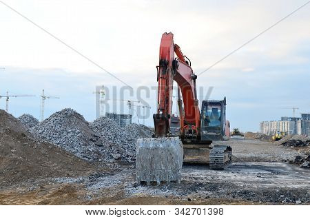 Excavator Loads Of Stone And Rubble For Processing Into Cement Or Concrete For Construction Work. Cr