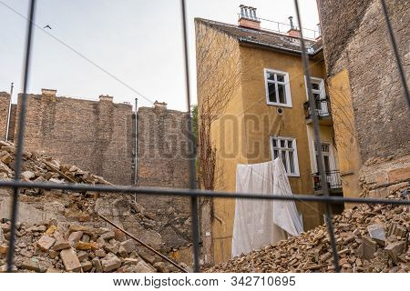 Old, Ruined And Collapsed Building Yard. Pile Of Bricks In Ancient Decay Wall Background