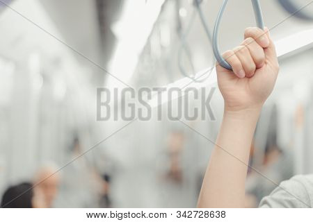 City Living Concept Male Hand Holding A Looped Handle In Urban Public Transportation