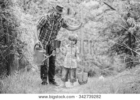 Dad Teaching Little Son Care Plants. Little Helper In Garden. Make Planet Greener. Growing Plants. T