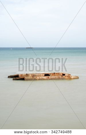 Ruins of harbor built by the Allies in Arromanches, Normandy, France.