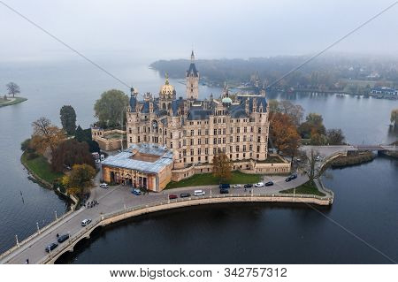 Aerial Drone Shot View Of Schwerin Palace Castle With Heavy Fog Haze In The Morning By Lake Schwerin