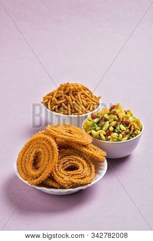 Indian Snack : Chakli, Chakali Or Murukku And Besan (gram Flour) Sev And Chivada Or Chiwada On Pink