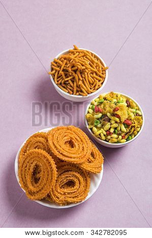 Indian Snack : Chakli, Chakali Or Murukku And Besan (gram Flour) Sev And Chivada Or Chiwada On Pink