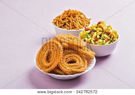 Indian Snack : Chakli, Chakali Or Murukku And Besan (gram Flour) Sev And Chivada Or Chiwada On Pink