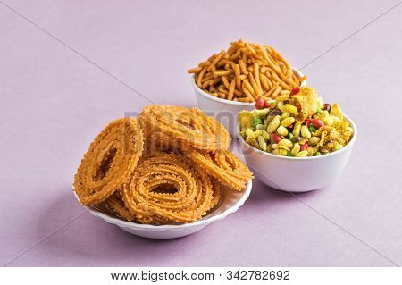 Indian Snack : Chakli, Chakali Or Murukku And Besan (gram Flour) Sev And Chivada Or Chiwada On Pink
