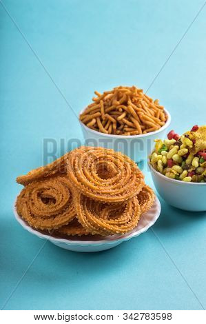 Indian Snack : Chakli, Chakali Or Murukku And Besan (gram Flour) Sev And Chivada Or Chiwada On Blue