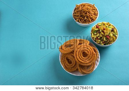 Indian Snack : Chakli, Chakali Or Murukku And Besan (gram Flour) Sev And Chivada Or Chiwada On Blue