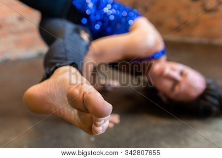 A Blurry Woman Is Seen In The Background As She Practices Yoga For A Healthy Body And Mind, Dirty An