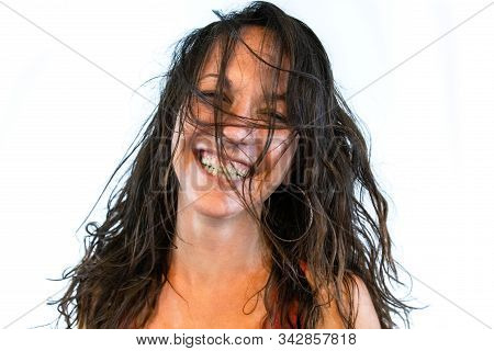 A Close Up And Frontal Portrait Of A Fun And Wild Caucasian Woman, With Unkempt Brunette Hair Coveri