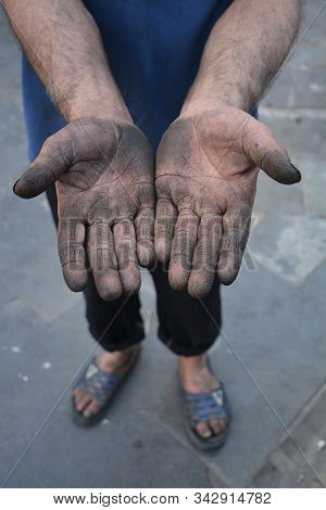 Hands Of Dirty And Painted Worker Who Have Succumbed To Intense Work Tempo And Have Cracks