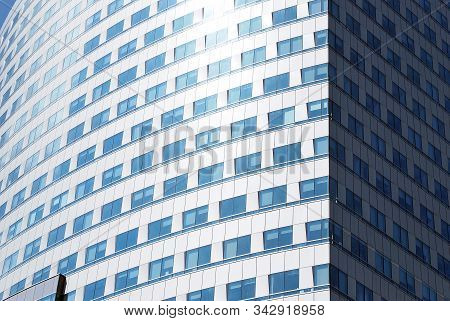 Geometric Reflection: Partly Cloudy Sky Reflected By Window Panes Of Office Building. Surface Of Gla