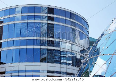 Geometric Reflection: Partly Cloudy Sky Reflected By Window Panes Of Office Building. Surface Of Gla