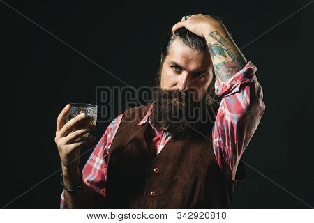 Bearded Businessman In Elegant Suit With Glass Of Whiskey. Sipping Whiskey. Bearded Handsome Man Hol