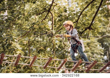 Balance Beam And Rope Bridges. Go Ape Adventure. Child Concept. Climber Child On Training. Portrait 