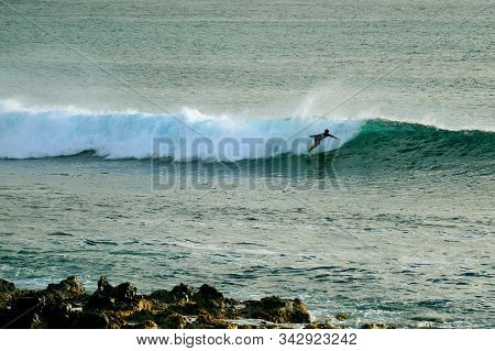 Talented Surfer On The Big Waves Of The Pacific Ocean At Hanga Roa, Easter Island, Chile
