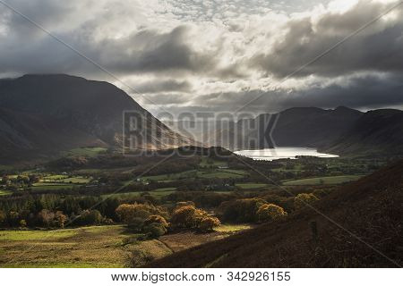 Epic Sun Beams Light Up Crummock Water In Dramatic Autumn Fall Landscape Image With Mellbreak And Gr