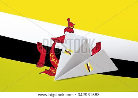 Brunei Darussalam Flag Depicted On Paper Origami Airplane. Handmade Arts Concept