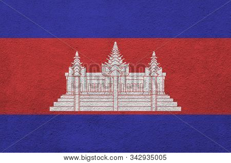 Cambodia Flag Depicted In Bright Paint Colors On Old Relief Plastering Wall. Textured Banner On Roug
