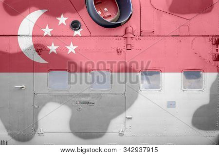 Singapore Flag Depicted On Side Part Of Military Armored Helicopter Closeup. Army Forces Aircraft Co