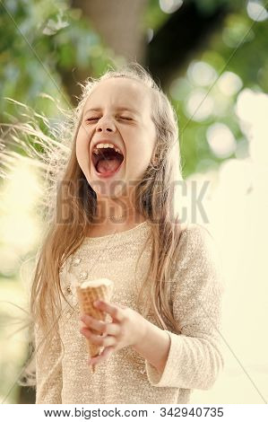 Ice Cream Makes Her Fall Into Euphoria. Cute Little Girl Eating Ice Cream On Summer Day. Small Child