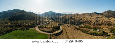 Aerial View Of A Scenic Road In The Dry Canadian Mountain Landscape During A Sunny Summer Day. Taken