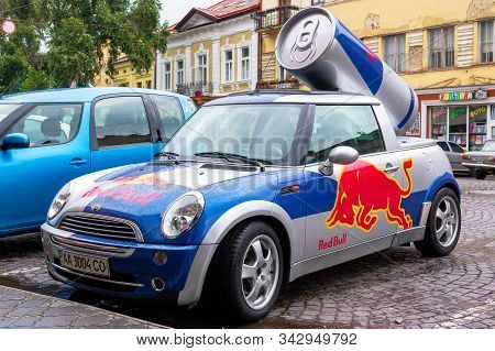 Uzhhorod, Ukraine - 14 Jul, 2013: Red Bull Mini Cooper Publicity Car With A Can Of Energy Drink Behi