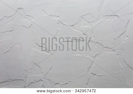 Abstract White Unobtrusive Background And Texture. A Plaster Wall With Old Cracked Layer Under New O