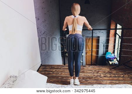 Attrctive Fitness Woman Doing Stretching Exercises At Home, As Part Of A Healthy Lifestyle Without G
