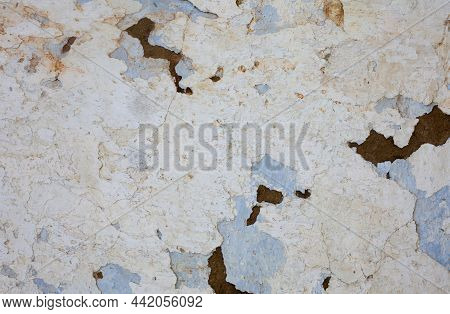 Old Whitewashed Wall With Rich And Various Texture. Cracked Plaster.