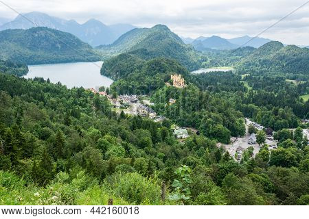 View From Neuschwanstein Castle In Germany Showing (left To Right): Palace Access Road; Alpsee With 