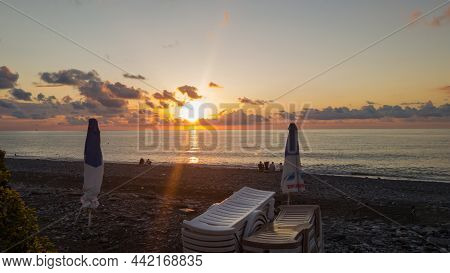 Batumi, Georgia - September, 2021: A Beautiful View Of Western Georgia, Sun Setting In The Sea, Pebb