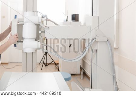 X-ray Department In Modern Hospital. Radiology Room With Scan Machine With Empty Bed. Technician Adj