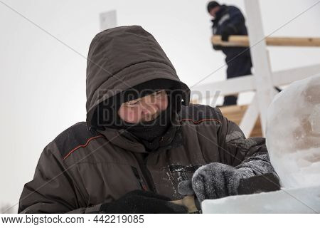 A Portrait Of A Fitter With A Hood On His Head
