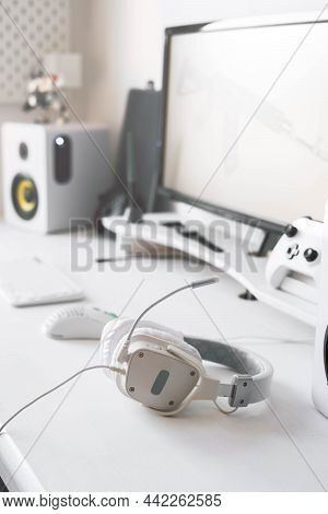 White Large Gaming Headphones Are On The Table. Close-up In A Bright Interior