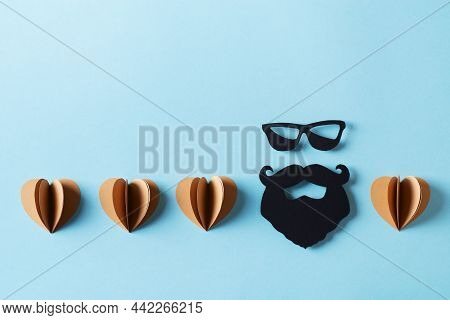 Fathers Day Concept With Craft Sustainble Paper Hearts And Moustache And Bread On Blue Background, T