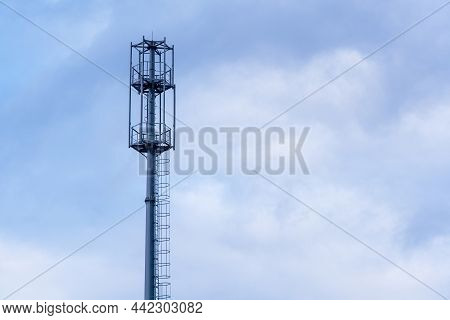 View Of An Unequipped Telecommunications Tower Of A Mobile Network Against The Sky. Communication Te