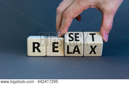 Relax And Reset Symbol. Businessman Turns Cubes And Changes The Word 'relax' To 'reset'. Beautiful G
