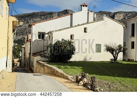 Narrow Street And Typical Whitewashed Facades Of The Town Of Beniarda In Alicante, Spain