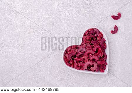 Dry Traditional Beetroot Pasta. Stone Background. Top View.