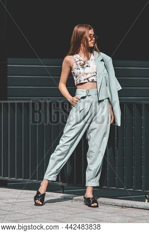 Fashion Portrait Of Young Woman Wearing Sunglasses, Top, Slingbacks, Blue Suit. Young Beautiful Happ