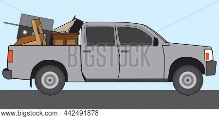A Gray Pickup Is Hauling A Load Of Old Trash To The Dump