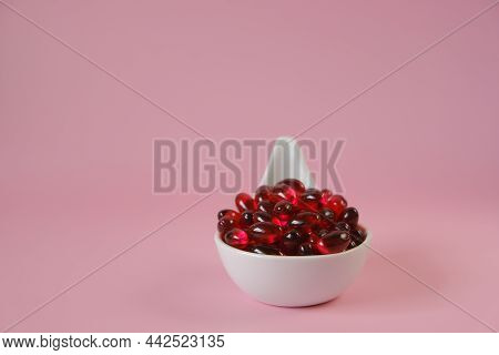Krill Oil Capsules In A Ceramic Spoon On A Pink Background.natural Supplements And Vitamin.omega Fat