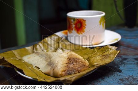 Stuffed Tamale Served On Wooden Table, Stuffed Tamale On Banana Leaf Served On Wooden Table, Typical