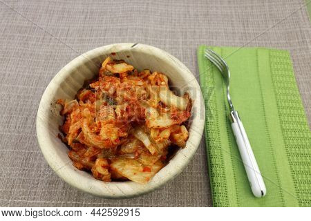 Fermented Meal Of Napa Cabbage, Radish And Seasonings Kimchi Recipe Ready To Eat From A Round Wood B
