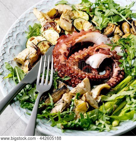 Coocked Grilled Tentacles Of Octopus, Sardines And Mussels