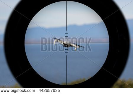 Gun Sight Pointing At A Drone Flying With The Ocean In The Background
