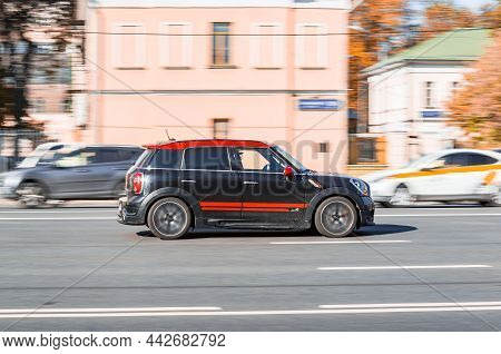 Mini Cooper All4 On The City Road. Fast Moving Black Car On Moscow Streets. Vehicle Driving On The S